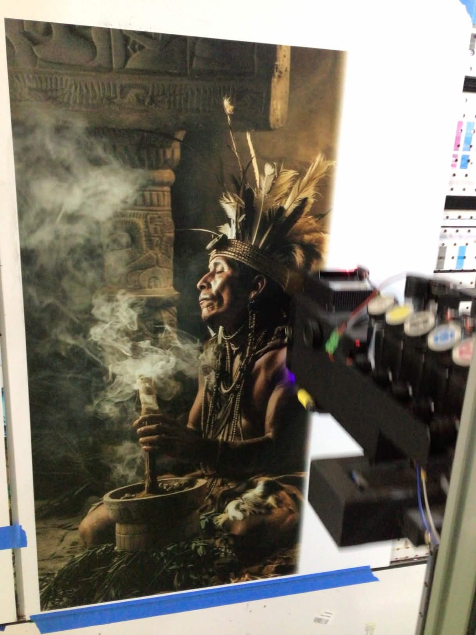 Indigenous ceremonial figure mural being printed on wall